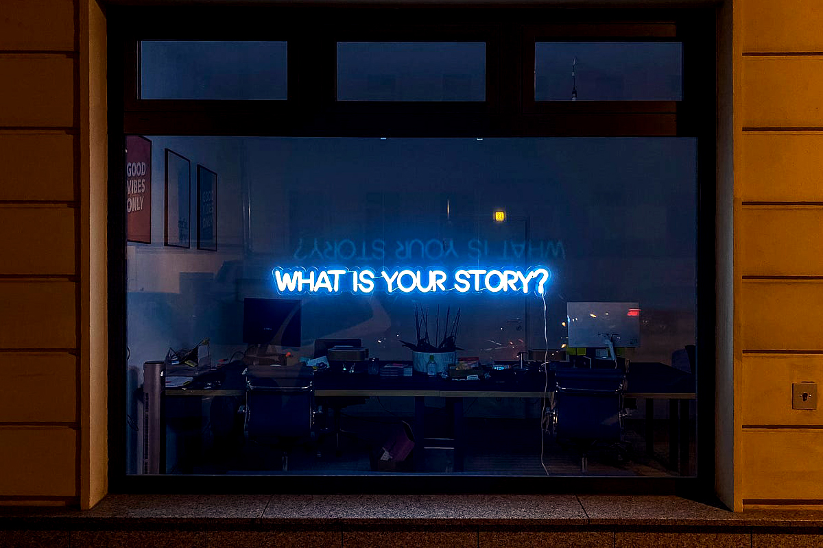 A window with the phrase What is your story? in the reflection, what is your story, personal story, personal story with chronic illness, chronic illness personal story